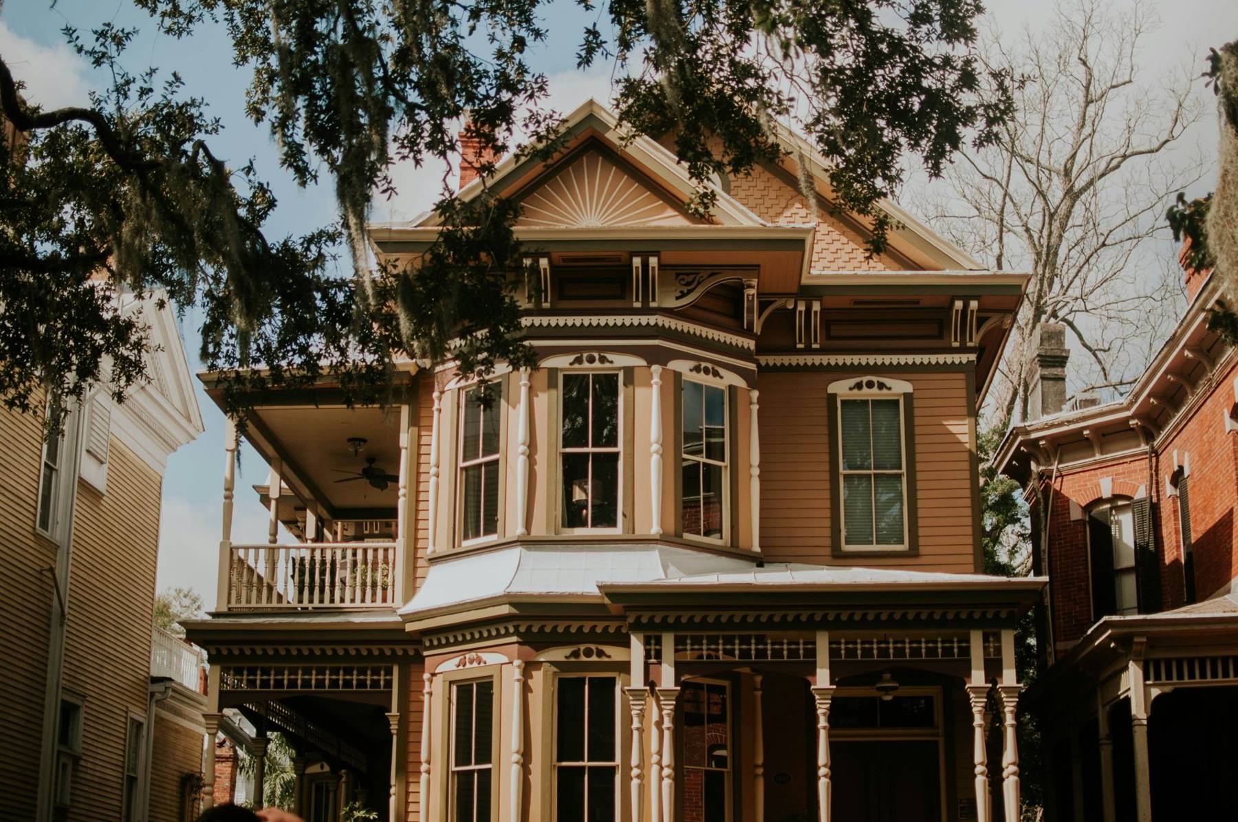 A restored Victorian house with a wraparound porch